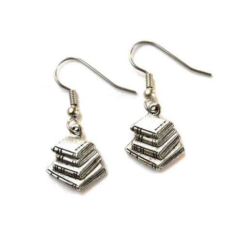 A pair of silver book stack earrings dangle from ear wires against a white background.